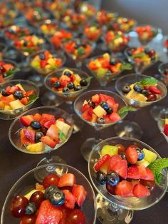 many small bowls filled with different types of fruit on top of a table next to each other