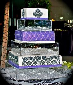 three tiered cake with purple and white designs