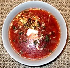 a white bowl filled with soup on top of a table