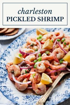 a blue and white plate with shrimp, pineapples and onions on it next to crackers