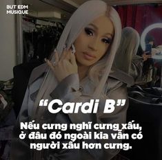 a woman talking on a cell phone in front of a mirror with the caption cardi b