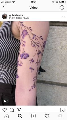 a woman's arm with purple flowers on it and the words video written below