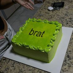 a green cake with the word brat on it