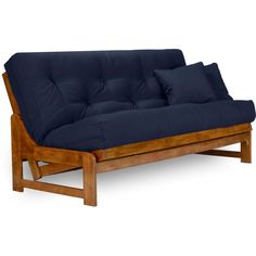 a wooden futon with blue cushions on it's back and arms, in front of a white background