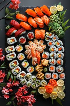 sushi platter with oranges, carrots and broccoli