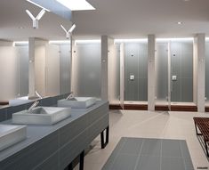 a public restroom with several sinks and stalls