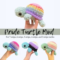 the crocheted turtle is being held up by two hands