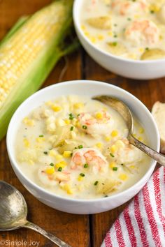 two bowls filled with shrimp chowee and corn on the cob