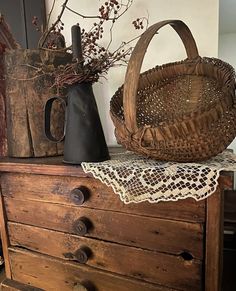 an old dresser with two baskets on it