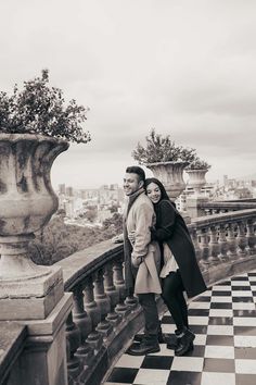 a man and woman standing next to each other on top of a checkered floor