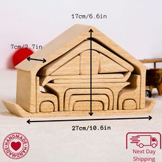 a wooden toy house is shown with measurements for the size and shape, along with a red rubber stamp that says next day shipping