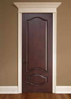 an empty room with a wooden door and hard wood flooring on the hardwood floors