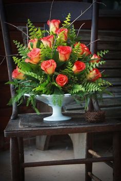 a vase filled with flowers sitting on top of a wooden table