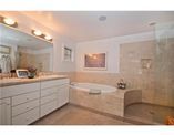 a large bathroom with two sinks and a bathtub next to a walk in shower