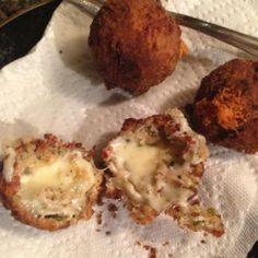 three different types of food sitting on top of a white napkin next to a fork