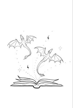 an open book with two dragon flying out of it