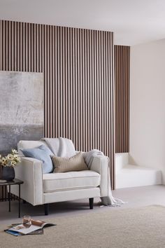 a living room with a white couch and striped wall