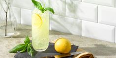 a lemon and basil drink on a cutting board