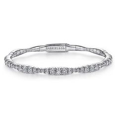 Add a little majestic flair to your bracelet stacking with this sparkling bangle style from our Demure collection. Comprised of a delicate 14K white gold base, its entire foundation is adorned with 1.87 ct diamonds that encompass the circumference in a graduating design feature. With just the right amount of sparkle to spare, this bangle is modest enough to pair with multiple bracelets while also stunning as a solo accessory. Stackable Diamond Bangle Bracelet, Diamond White Stackable Diamond Bracelets, White Gold Diamond Cut Cuff Bracelet, Stackable Diamond Bangle Bracelets, Wedding Cuff Bracelet In White Gold With Diamond Cut, White Gold Cuff Bracelet With Diamond Cut For Wedding, Wedding White Gold Cuff Bracelet With Diamond Cut, White Gold Diamond Cut Bangle Bracelet, Stackable Diamond Bracelet For Anniversary