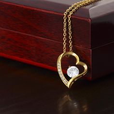 The dazzling Forever Love Necklace is sure to make her heart melt! This necklace features a stunning 6.5mm CZ crystal surrounded by a polished heart pendant embellished with smaller crystals to add extra sparkle and shine. Beautifully crafted with either a white gold or yellow gold finish, be sure to give her a classic gift she can enjoy everyday. 14k white gold finish or 18k yellow gold finish 6.5mm round cut cubic zirconia stone Pendant dimensions: 0.8" (2.2cm) height / 0.7" (1.8cm) width Adju Medias Red, Beauty Forever, Crystal Heart Pendant, Gold Jewelry Necklace, Forever Love, Love Necklace, Crystal Heart, Gold Heart, Heart Pendant Necklace