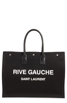 Perfect for days when you're toting a lot but still want to look Left Bank-chic, this spacious canvas tote features rolled leather handles and a bold logo. Style Name:Saint Laurent Noe Rive Gauche Logo Canvas Tote. Style Number: 6084311. Available in stores. Ysl Tote Bag, Ysl Tote, Saint Laurent Tote, Ysl Handbags, Fabric Tote Bags, Bold Logo, Handbag Handles, Fabric Tote, Girls Purse