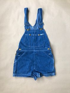 Unworn, originating from the archive of a jeans shop that closed down late last century.  Unworn vintage Lee Cut Off Shorts with tag still attached.  100% cotton, sized W28, made in USA. Pockets in the front and back and two bib pockets.  Waist from top of waistband: 71cm / 28" For information about our full terms & conditions please review our Shop Policies. Vintage Blue Bottoms With Pockets, Vintage Medium Wash Washed Overalls, High Waist Cotton Medium Wash Shortalls, Vintage Cotton Bottoms In Medium Wash, High Waist Medium Wash Cotton Shortalls, Vintage Medium Wash Cotton Bottoms, Vintage Denim Blue Bottoms With Pockets, Vintage Denim Blue Overalls, Vintage Medium Wash Overalls With Pockets