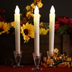 three lit candles sitting next to each other on a table