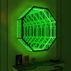 a mirror that is lit up in the dark with green lights on top of it