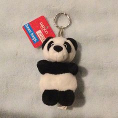 a panda bear keychain with a credit card attached to it