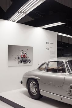 an old car is on display in a museum