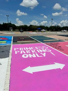 a parking lot that has been painted pink and white with an arrow pointing to princess parking only