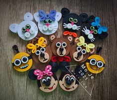 a group of mickey mouses made out of paper plates and magnets on a wooden table