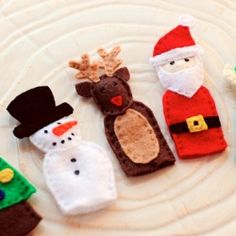 christmas decorations made out of felt on a plate with snowman, santa clause and reindeer