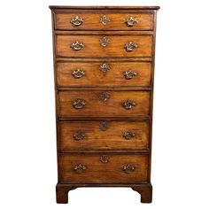 an old wooden dresser with many drawers and knobs on the front, against a white background