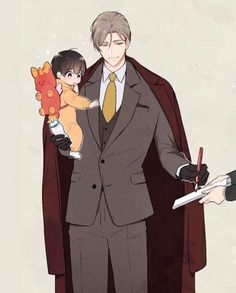 a man in a suit and tie holding a small child while standing next to an adult