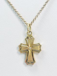 This stunning pre loved gold cross pendant, featuring a beautifully designed cross adorned with a sparkling diamond at its center. Crafted from 18ct gold it features a unique design and detailed edges. Approximately 19.5mm x 16mm Weighs approximately 3.10gm Necklace is for display purposes only. Yellow Gold Diamond-cut Cross Pendant, Gold Diamond Cut Cross Necklace, Yellow Gold Diamond Cut Crucifix Necklace, Diamond Cut Yellow Gold Cross Pendant, Yellow Gold Cross Pendant For Anniversary, Yellow Gold Diamond Cut Cross Pendant, Yellow Gold Diamond Cut Cross Pendant Necklace, Yellow Gold Cross Necklace For Anniversary, Hallmarked Yellow Gold Cross Necklace