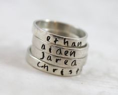 Hand forged, hand stamped with letters, shaped, soldered, and hand finished. - Engraved with up to 15 characters - Band is 3mm wide by 1mm thick - .925 solid sterling silver - Please include personalization (name) on checkout page, notes section For sizing help: if purchasing multiples to wear together, it's best to order approx 1/2 bigger than the normal size ring you would wear. MY SHOP ♥ http://LustrousElements.etsy.com JOIN ME ON FACEBOOK ♥ to hear about Specials and Promotional Give-Aways h Sterling Silver Hand Stamped Stackable Rings As Gift, Hand Stamped Sterling Silver Stackable Rings As Gift, Personalized Name Sterling Silver Stackable Rings, Personalized Silver Ring With Name, Silver Stackable Rings With Custom Name For Gift, Silver Engraved Ring With Names For Gift, Sterling Silver Stackable Name Rings Gift, Silver Hand-stamped Engraved Ring, Silver Hand Stamped Stackable Promise Rings