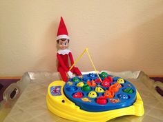 the elf is playing with his toys on the table in front of the toy tray