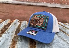 Daisy Patch Hat with Turquoise Southwestern Border. Hand tooled daisy and turquoise southwestern border. The turquoise border is painted with four different tones of turquoise. Sewn onto the popular Richardson 115, the perfect trucker hat. Handmade Southwestern Blue Hat, Southwestern Turquoise Hat With Curved Brim, Turquoise Western Hat With Curved Brim, Kimes Ranch Hat Teal, Southwestern Turquoise Brimmed Hat, Daisy Patches, Patch Hat, Blue Daisy, Heathers