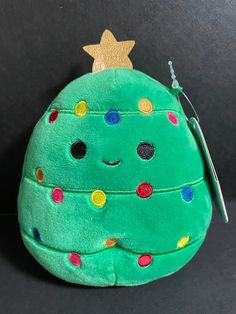 a green stuffed toy with a star on top