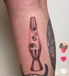 a tattoo on the leg of a man with an image of a blender and mustache