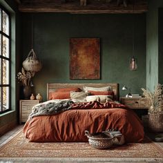 a bedroom with green walls and an orange bedspread in front of a large window