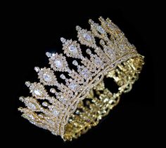 a gold tiara on a black background