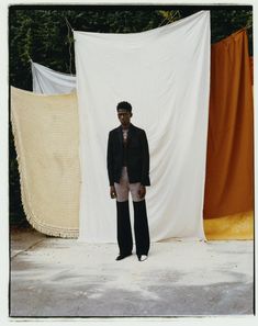 a man standing in front of a white backdrop