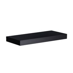 a black shelf sitting on top of a white wall