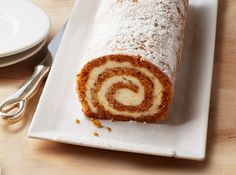 a roll on a plate with powdered sugar