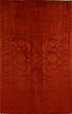 an orange area rug with designs on the bottom and sides in different shades of red