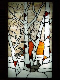 a stained glass window with trees in the background