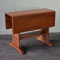 a small wooden desk with one drawer open