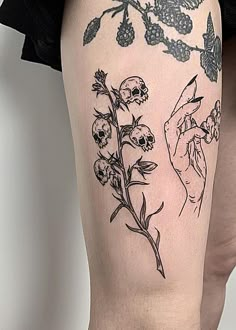 a woman's leg with tattoos and flowers on it